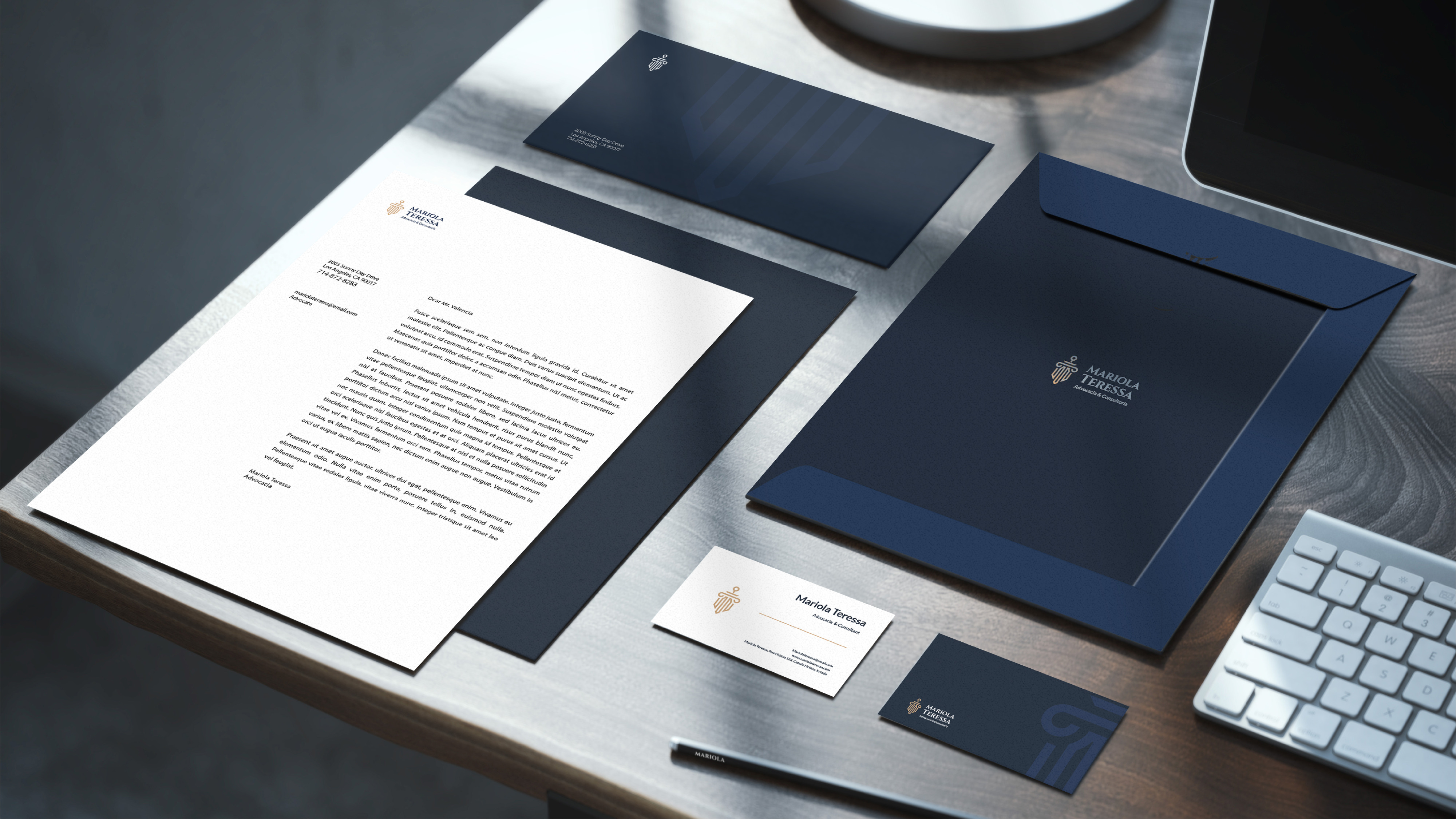 Stationery suite — letterhead, envelopes, business cards on walnut desk
